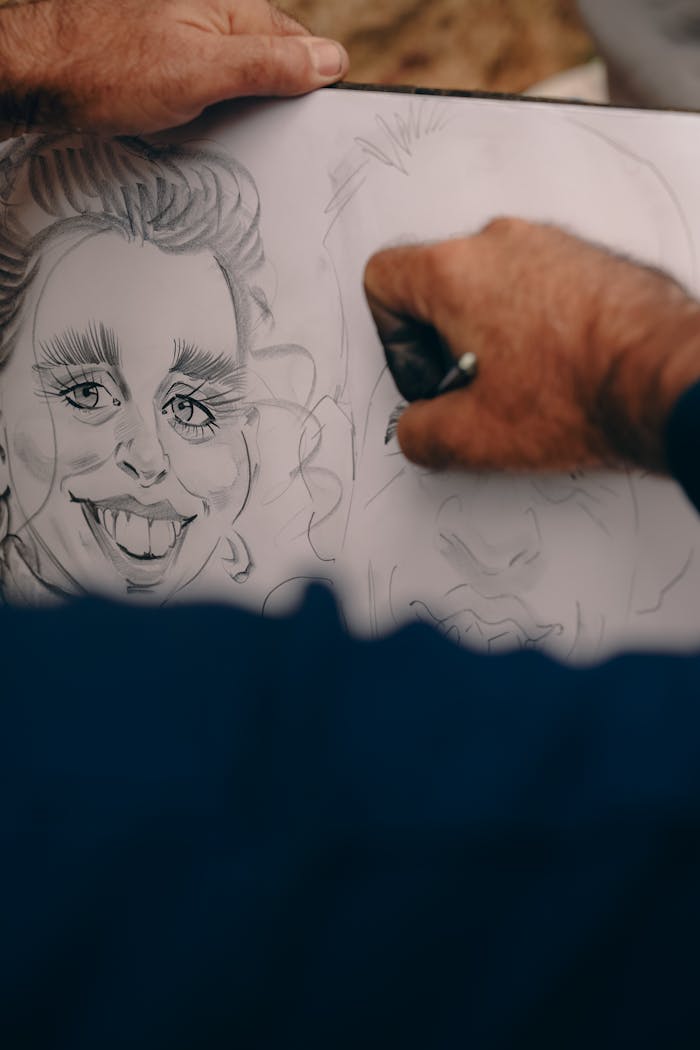services-03 Close-up of hands drawing caricatures on paper, capturing creative artistry.